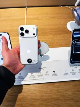 Holding an iPhone 17 Pro with Triple Camera on Display in a Tech Store Show.. Stock Photos