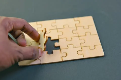 Holding Jigsaw puzzle with missing piece business concept for completing th.. Stock Photos