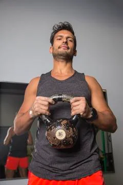 Holding a kettlebell Stockfoto's