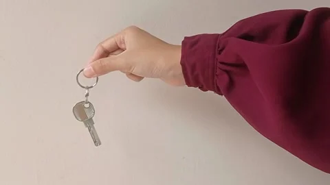Holding a key on a hand with red sweater Stock Footage 150665807