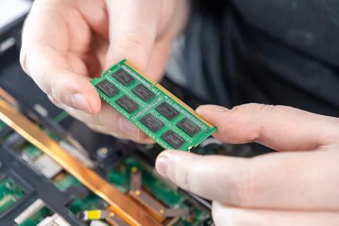 Holding a laptop RAM module during disassembly for upgrade or replacement Stock Photos