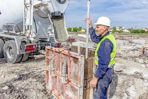 Holding leveling rod to measuring level on construction site Stock Photos