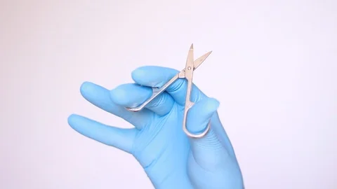 Holding manicure scissors in blue gloves Stock Footage 96239956