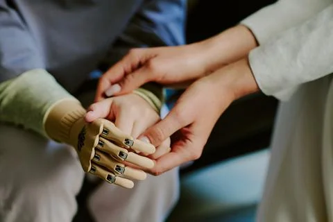 Holding Metal Prosthetic Hand in Gentle Support Stock Photos