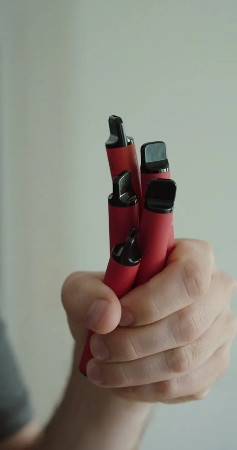 Holding Multiple Vape Devices – E-Cigarette and Modern Lifestyle Concept Stock Footage 334109218