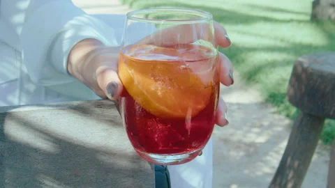 Holding a negroni drink Stock Footage 308465397