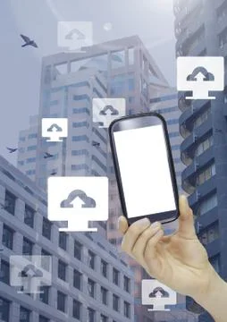 Holding phone and Computer cloud upload icons in city Stock Photos