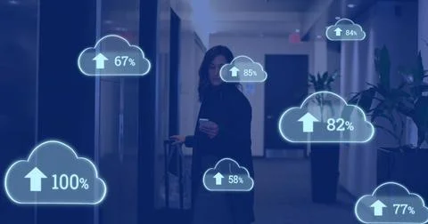 Holding phone and pulling suitcase, woman wearing dark coat walking hotel Stock Photos