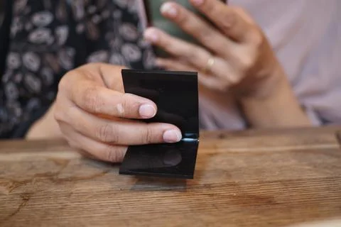 Holding a phone to scan a QR code in a cafe Foto stock