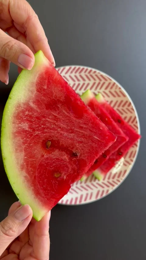 Holding a plate of watermelon Stock Footage 343543981