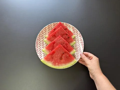 Holding a plate of watermelon Stock Photos