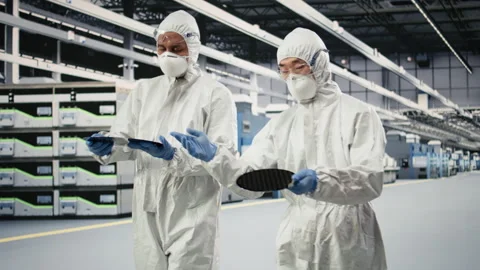 Holding processed silicon wafer, automation and multiethnic team of specialists Stock Footage 333393829