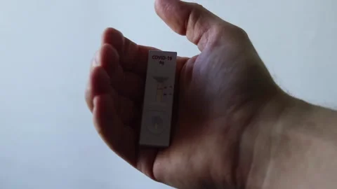 Holding Rapid Diagnostic Test Kit Showing Negative Line Result For Stock Footage 149220122