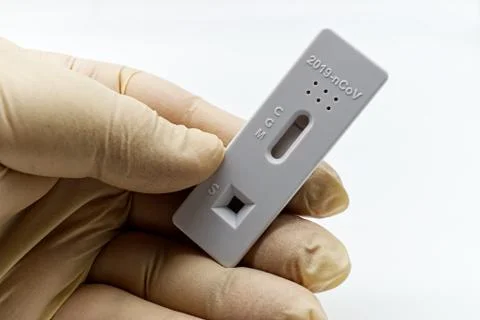 Holding a rapid test device for serological Covid-19 IgG/IgM test. Stock Photos