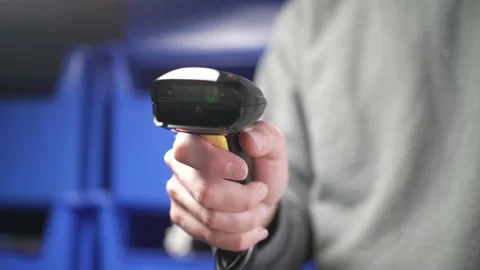 Holding a Red Laser Bar Code Scanner in a Warehouse Closeup Stock Footage 185118516