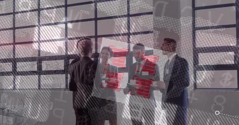 Holding red presentation board, five team members in suits pointing and Stock Photos