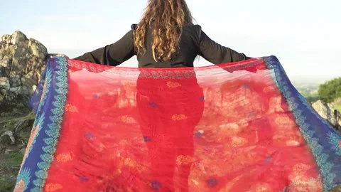 Holding Red Scarf While Walking up to Hill Summit Stock Footage 139146355