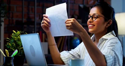 Holding reports and smiling, Indian businesswoman checks financial papers Stock Footage 342573743