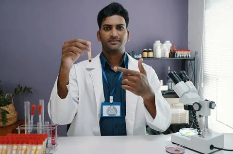 Holding Sample Entering Data In Laboratory Setting Stock Photos