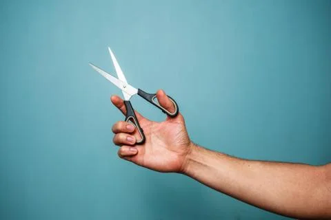 Holding scissors Photos