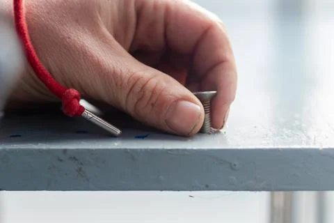 Holding a screw Stock Photos