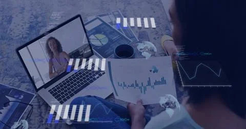 Holding single-sheet bar and pie chart, man wearing t-shirt sitting on rug near Stock Photos