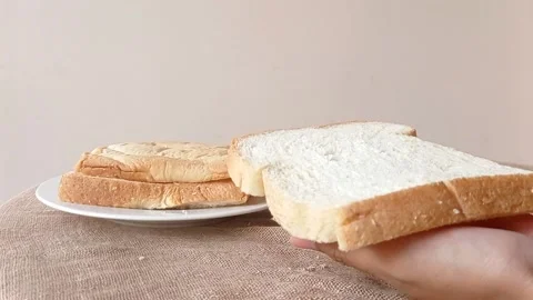 Holding a slice of bread on a hand Stock Footage 146256548