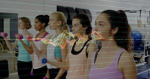 Holding small hand weights, five women in athletic wear exercising in gym with Stock Photos