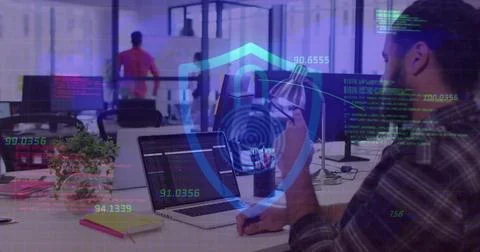 Holding smartphone and reviewing code on laptop at modern workspace with shield Stock Photos