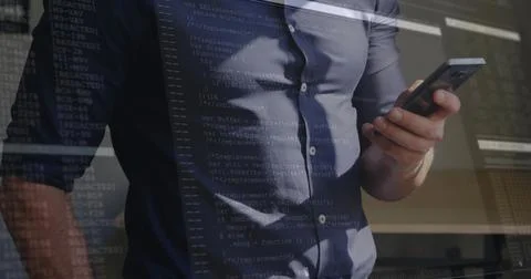 Holding smartphone developer in button-down shirt reviewing code at office, with Stockfoto's