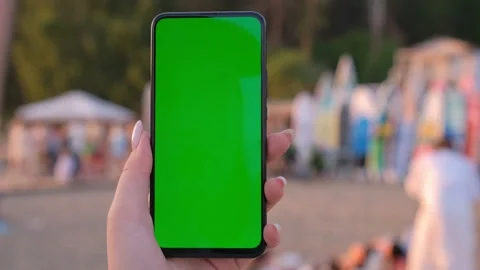 Holding smartphone with green screen chroma key over sunset at sea at tropical Stock Footage 272632684