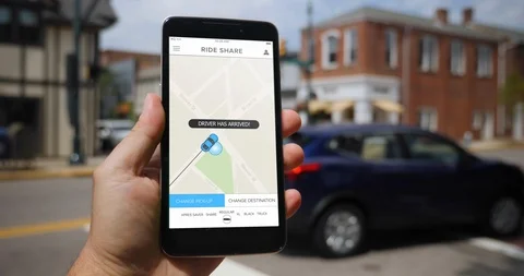 Holding Smartphone with Ride Sharing App as Driver Arrives Stock Footage 114031729