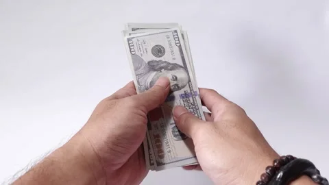 Holding a stack of crisp 100-dollar US currency notes. Stock Footage 313294787