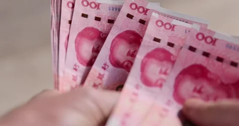 Holding a stack of red yuan in hand, holding a large amount of money in the Stock Footage 313179440