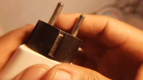 Holding a standard EU electrical power plug 스톡 동영상 341370995