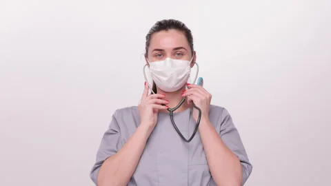 Holding a stethoscope, preparing to use it. Stock Footage 276550673