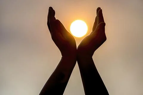 Holding the sun in two hands. Stock Photos