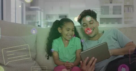Holding tablet, dad pale-tee girl green-polo pink-pants watching chat overlays Stock Photos