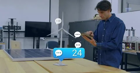 Holding tablet, denim tech inspecting turbine and solar panel bench with blue 写真素材