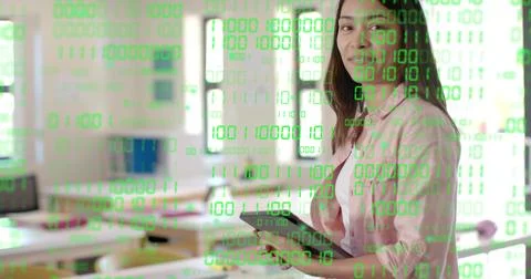 Holding tablet instructor wearing pink shirt showing green binary overlay in  Foto stock
