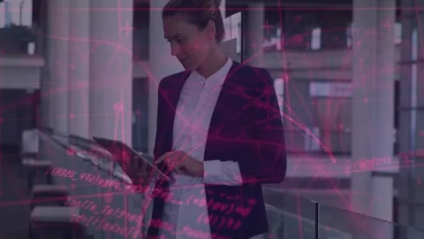 Holding tablet, woman in blazer checking data and tapping at atrium glass Stock Footage 334315831