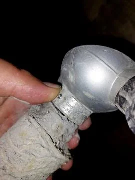 Holding a Temperature Sensor During a Field Inspection in a Dimly Lit Indus.. Stock Photos