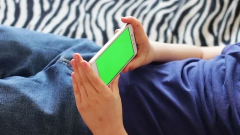 Holding Touchscreen Device, Close-up of boy hands using a smart phone. chroma Stock Footage