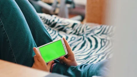 Holding Touchscreen Device, Close-up of female hands using a smart phone. chroma Stock Footage