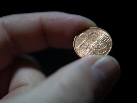 Holding a Two-Cent Euro Coin with Fingers Stock Photos