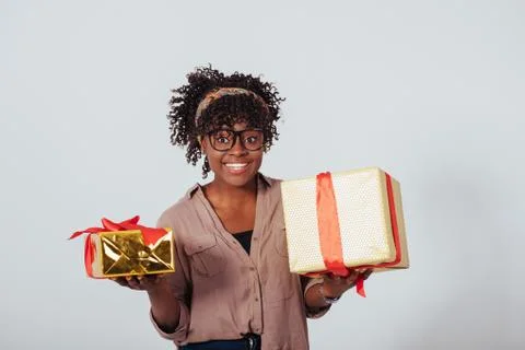 Holding two gift boxes and smiling. Holidays and celebration conception. Beau Stock-Fotos