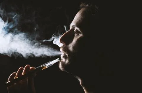 Holding vaping device or electronic cigarette Stock Photos