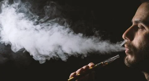 Holding vaping device or electronic cigarette Stock Photos