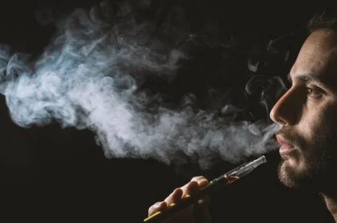 Holding vaping device or electronic cigarette Stock Photos
