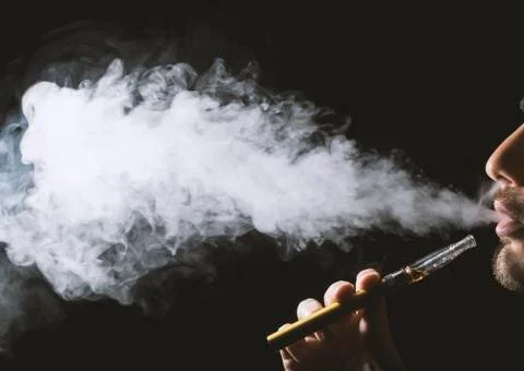 Holding vaping device or electronic cigarette Stock Photos